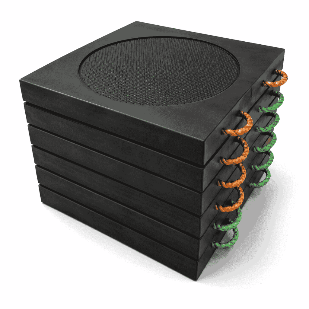 Heavy-duty UHMWPE crane outrigger pad placed beneath a hydraulic support leg on muddy ground